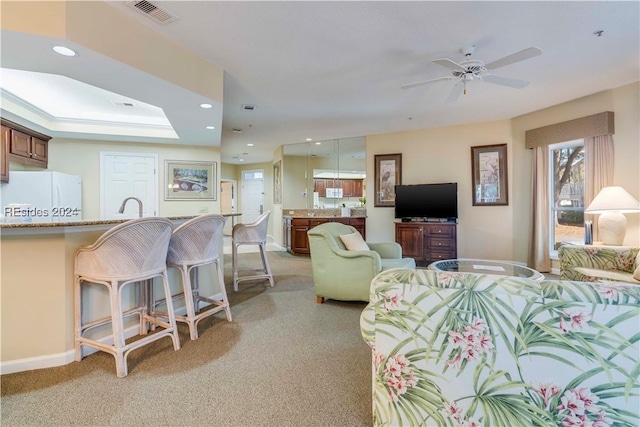 living room featuring ceiling fan and sink