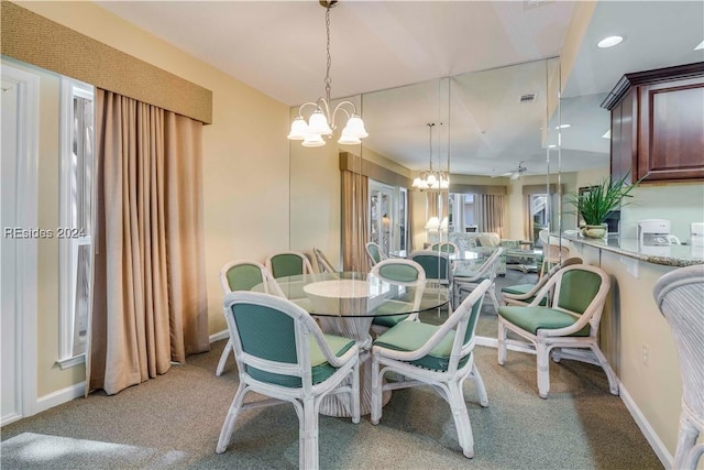 dining room featuring a chandelier and light carpet