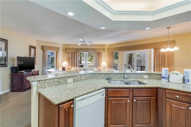 kitchen with dishwasher, light stone countertops, sink, and crown molding