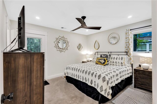 carpeted bedroom with multiple windows and ceiling fan