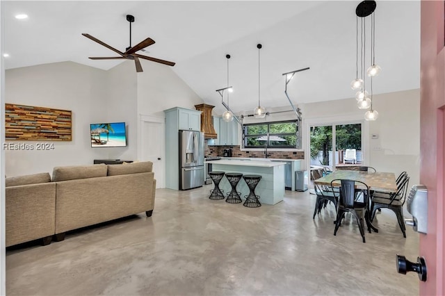 living room with ceiling fan, sink, and high vaulted ceiling