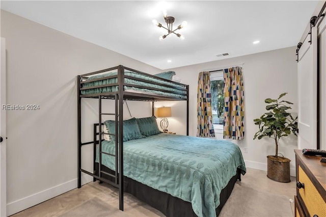 bedroom featuring a barn door and concrete floors