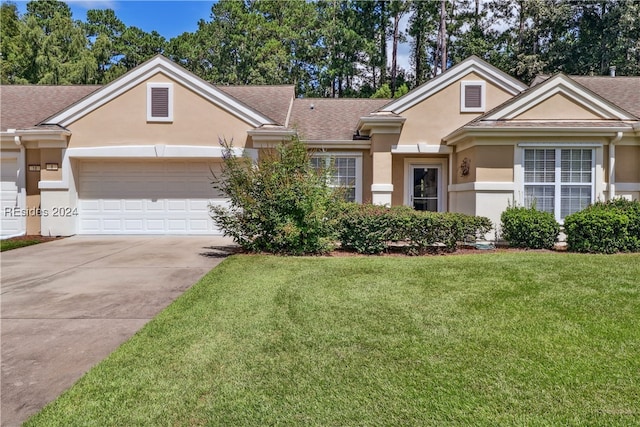 ranch-style home with a garage and a front lawn