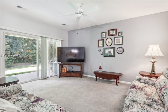 carpeted living room with ceiling fan