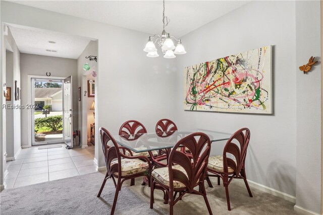 tiled dining area with a chandelier