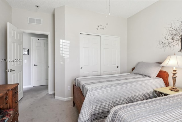 bedroom with light carpet and a closet