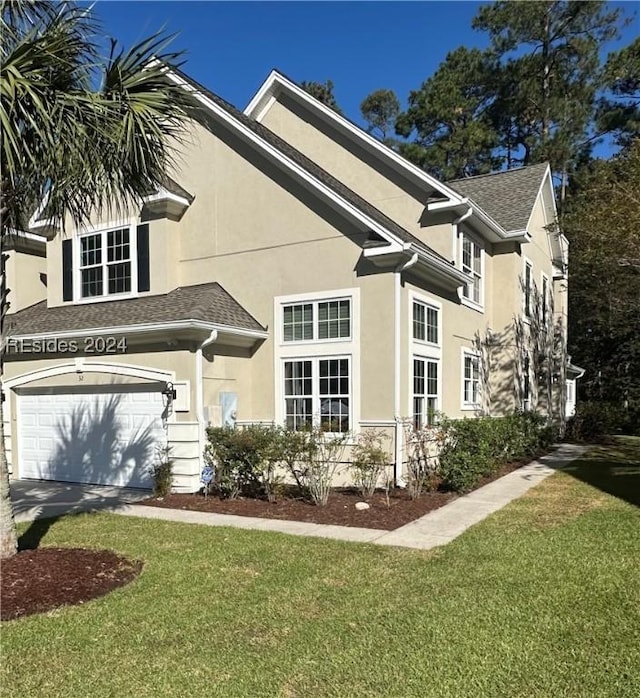 view of front of house with a garage and a front yard