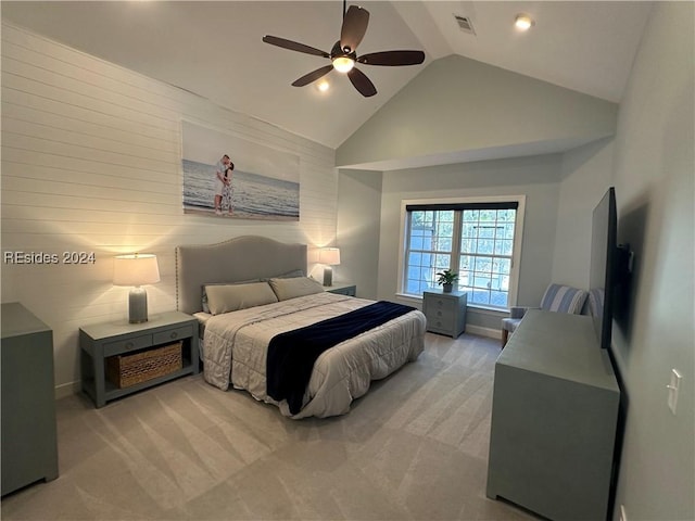 bedroom with ceiling fan, high vaulted ceiling, and light carpet