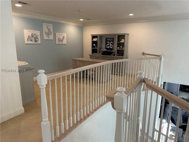 hallway with ornamental molding and carpet floors