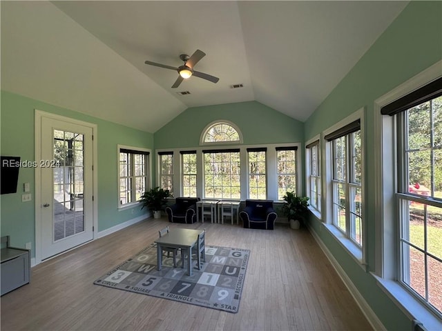 sunroom / solarium with lofted ceiling and ceiling fan