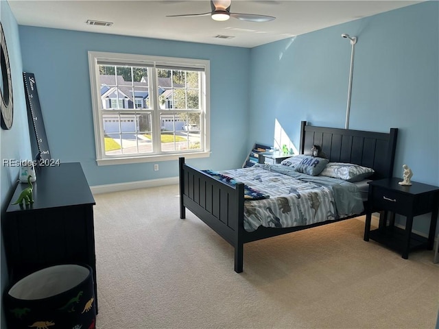 bedroom featuring light colored carpet and ceiling fan