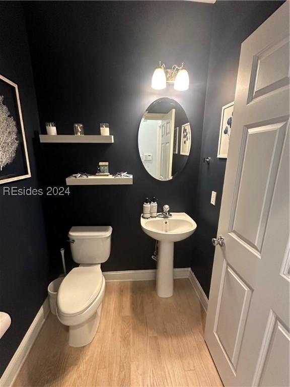 bathroom with hardwood / wood-style floors and toilet