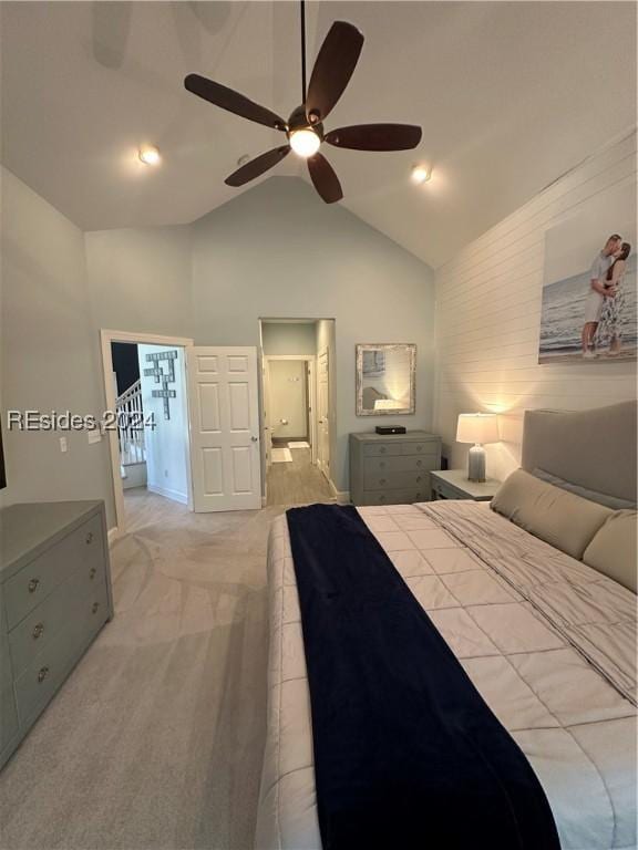 carpeted bedroom featuring lofted ceiling and ceiling fan