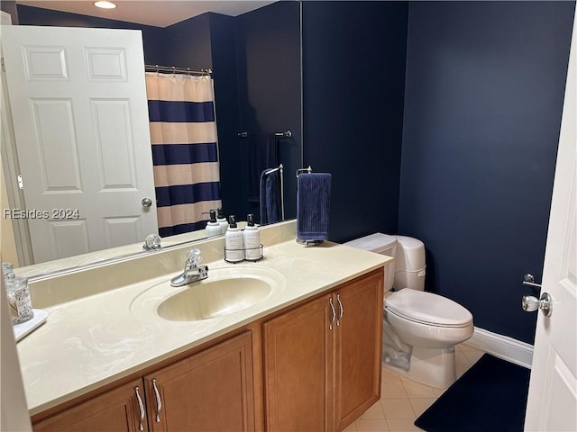 bathroom with tile patterned flooring, vanity, and toilet