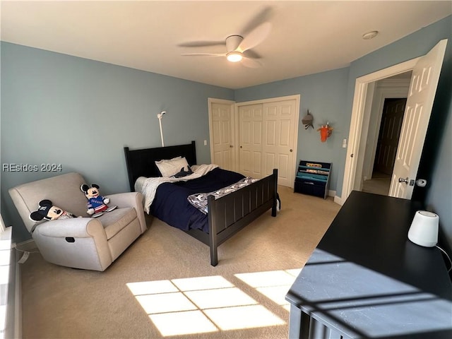 carpeted bedroom with ceiling fan and a closet