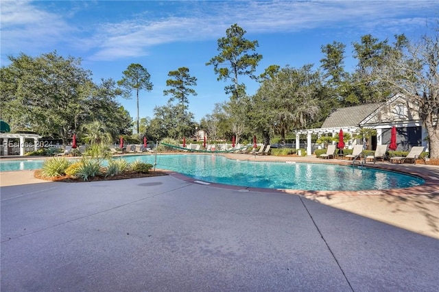 view of pool with a patio and a pergola