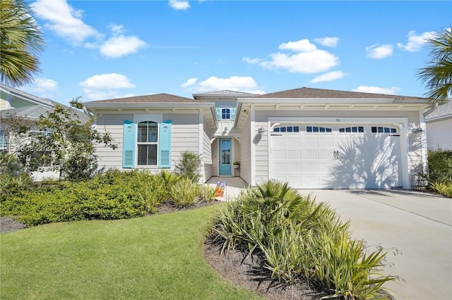 view of front of property featuring a garage and a front lawn