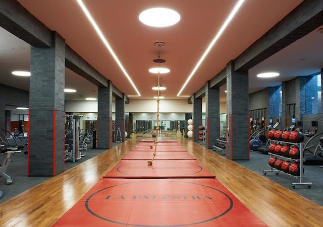 interior space with dark hardwood / wood-style flooring and ornate columns