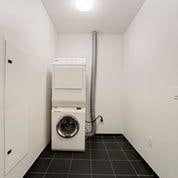 washroom with dark tile flooring and washer / clothes dryer