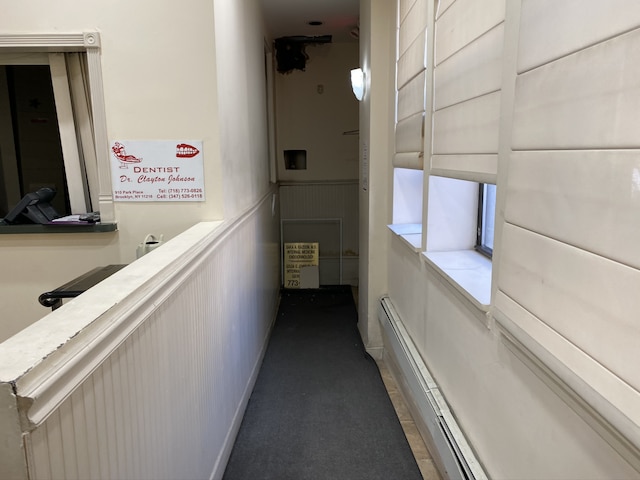 hall featuring a baseboard heating unit