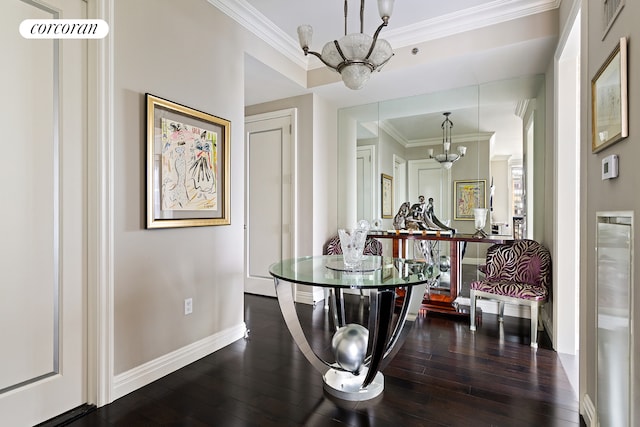 dining room with crown molding, dark wood-type flooring, and a notable chandelier