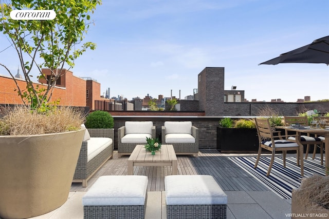 view of patio featuring a balcony and an outdoor living space