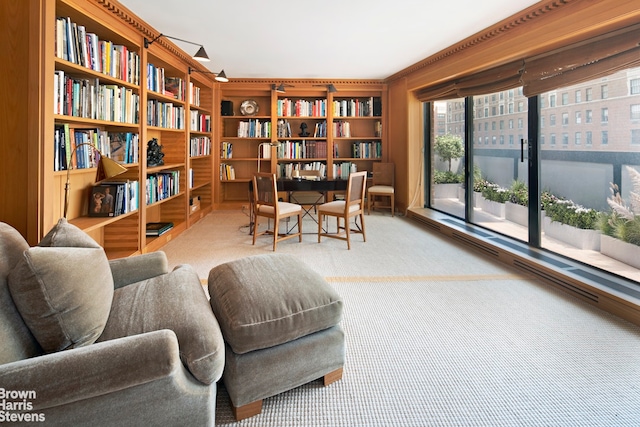 sitting room featuring light carpet and built in features