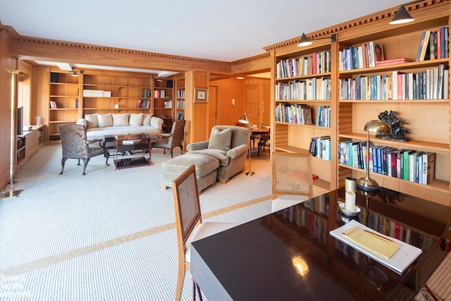 interior space featuring carpet, built in features, ornamental molding, and wooden walls