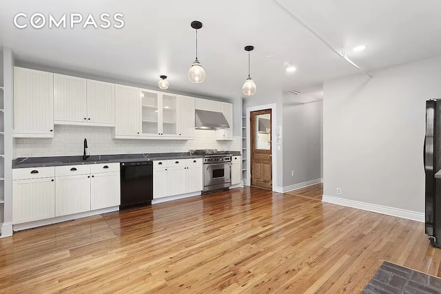 kitchen with light hardwood / wood-style flooring, backsplash, wall chimney exhaust hood, and black appliances