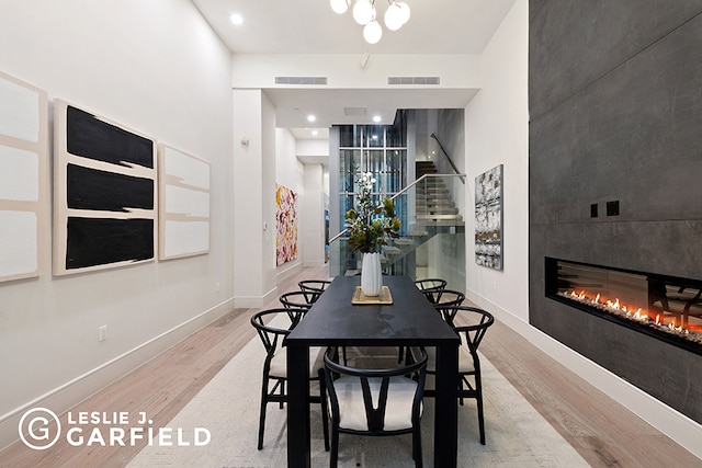 dining room featuring a notable chandelier and light wood-type flooring