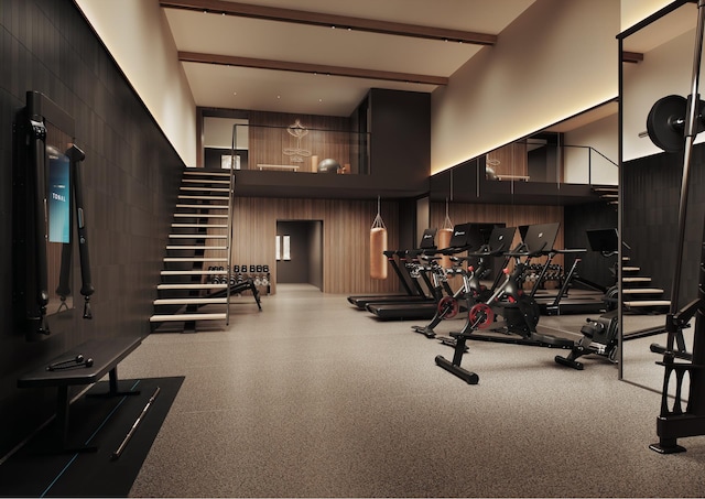 exercise room with a high ceiling