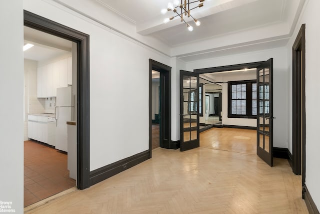 corridor with light parquet floors, ornamental molding, and a chandelier