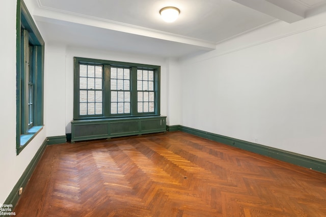 spare room featuring dark parquet floors, beamed ceiling, and radiator heating unit