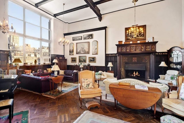 interior space with beam ceiling, dark parquet flooring, a towering ceiling, and an inviting chandelier