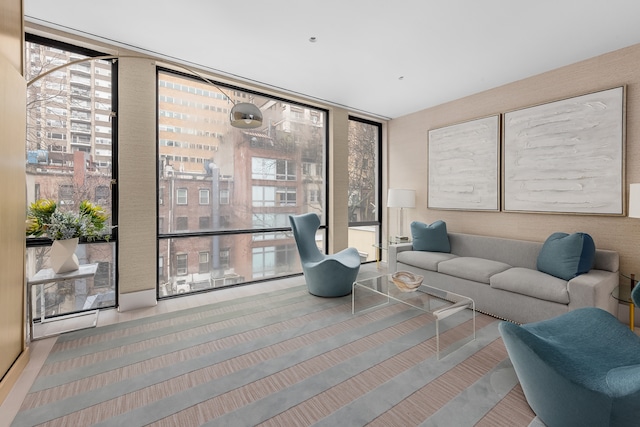 living room featuring a wall of windows and plenty of natural light