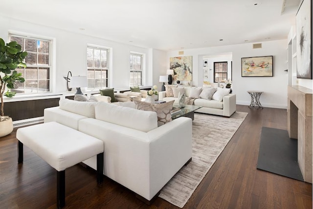 living room featuring dark hardwood / wood-style flooring and a high end fireplace