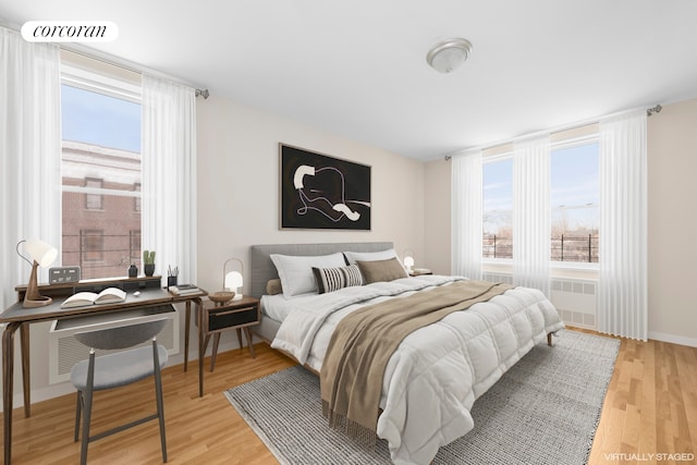 bedroom featuring multiple windows and light wood-type flooring