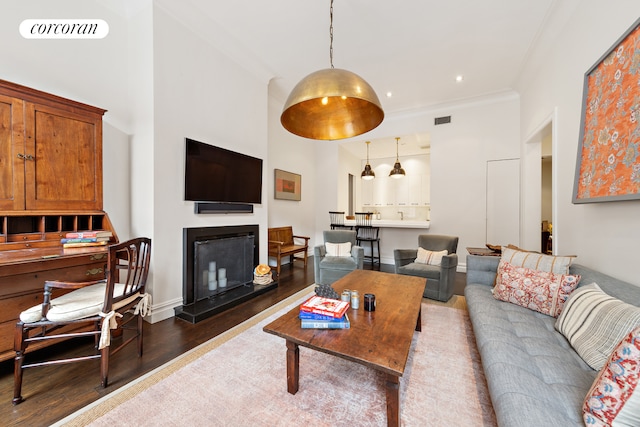 living room featuring dark hardwood / wood-style floors and ornamental molding