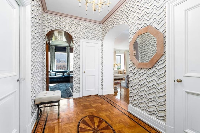 hall with parquet floors and crown molding