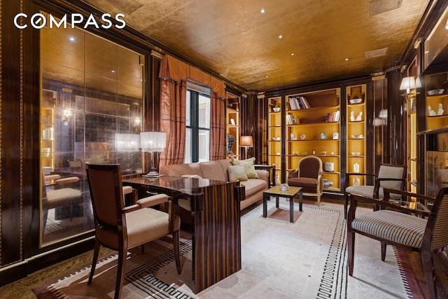 interior space featuring built in shelves and ornamental molding