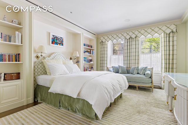 bedroom featuring crown molding and light hardwood / wood-style floors