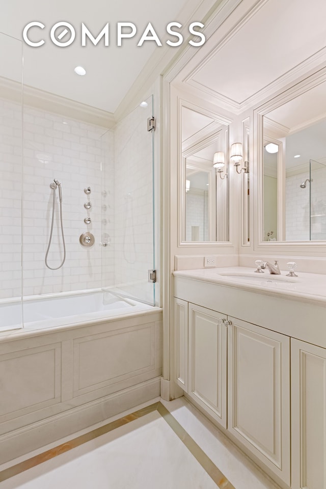 bathroom with ornamental molding, vanity, and tiled shower / bath combo