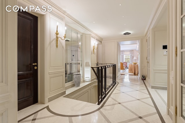 hallway featuring crown molding and light tile floors