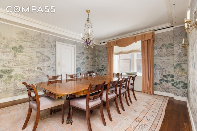 dining area featuring a notable chandelier, crown molding, and light wood-type flooring