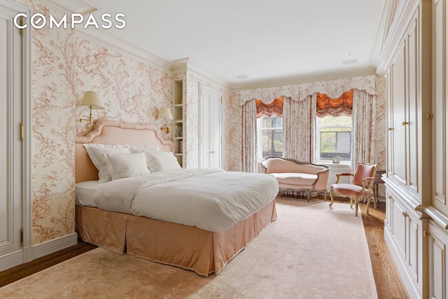 bedroom featuring light hardwood / wood-style flooring and ornamental molding