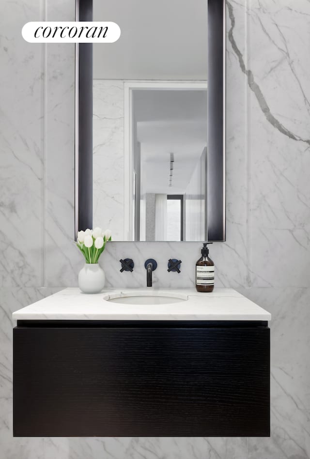 bathroom with tile walls and vanity