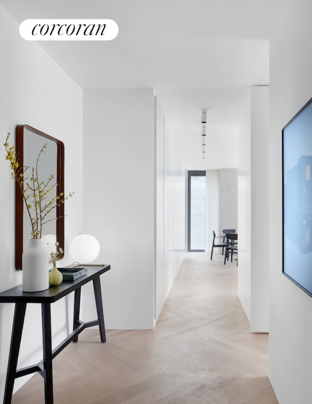 corridor featuring light parquet flooring