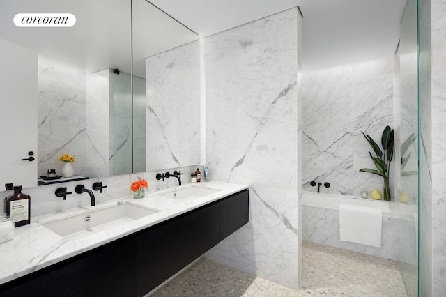 bathroom with vanity, tile walls, and shower with separate bathtub