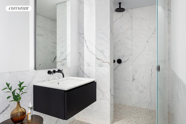 bathroom featuring tiled shower, tile walls, and vanity