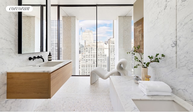 bathroom featuring vanity and a wall of windows